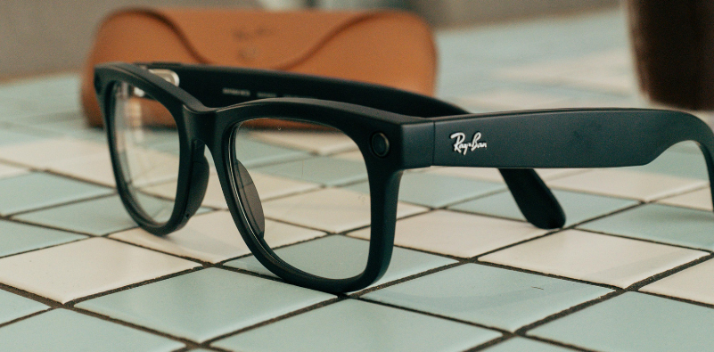 A pair of Ray-Ban Meta glasses on a blue and white tiled counter.