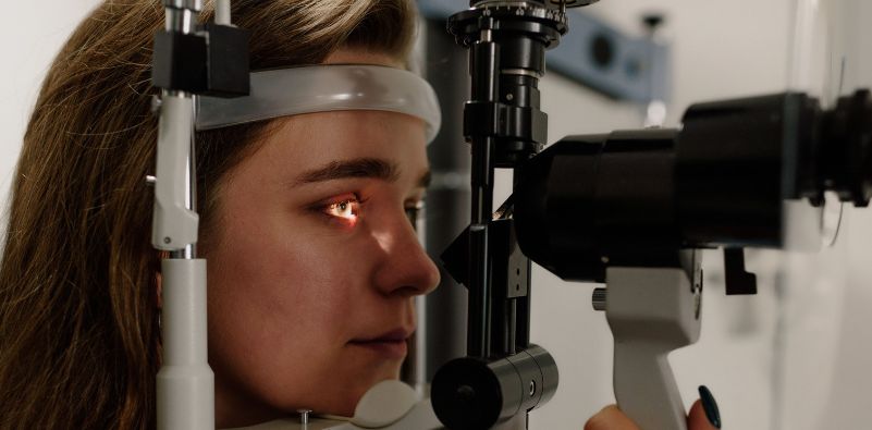 A close-up of a woman during her eye exam at the opticians