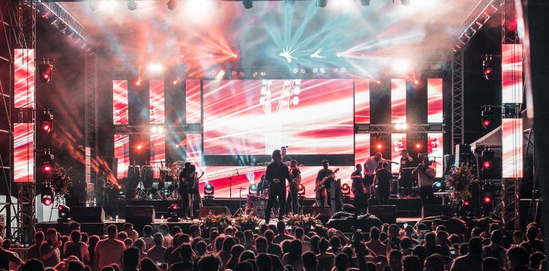 A band performing at a music festival in front of an audience