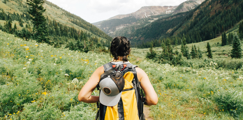 A woman hiking through the countryside.