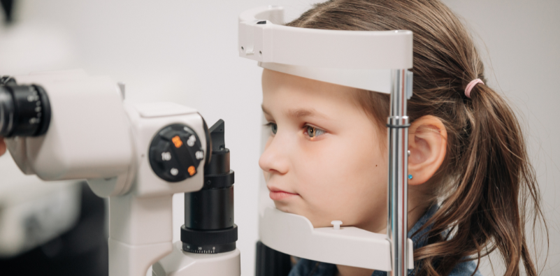 Primary school child having her eyes examined at the opticians